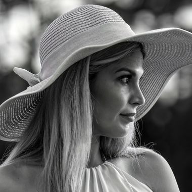 Black-and-white profile portrait in a wide-brim hat