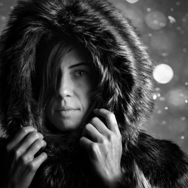 Black-and-white portrait framed by a textured hood